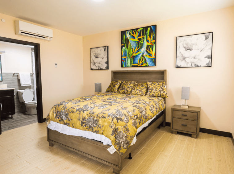 Side view of the bedroom with a bed that has a yellow comforter