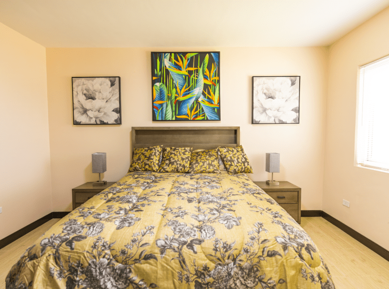 Front view of the bedroom with a bed that has yellow comforter