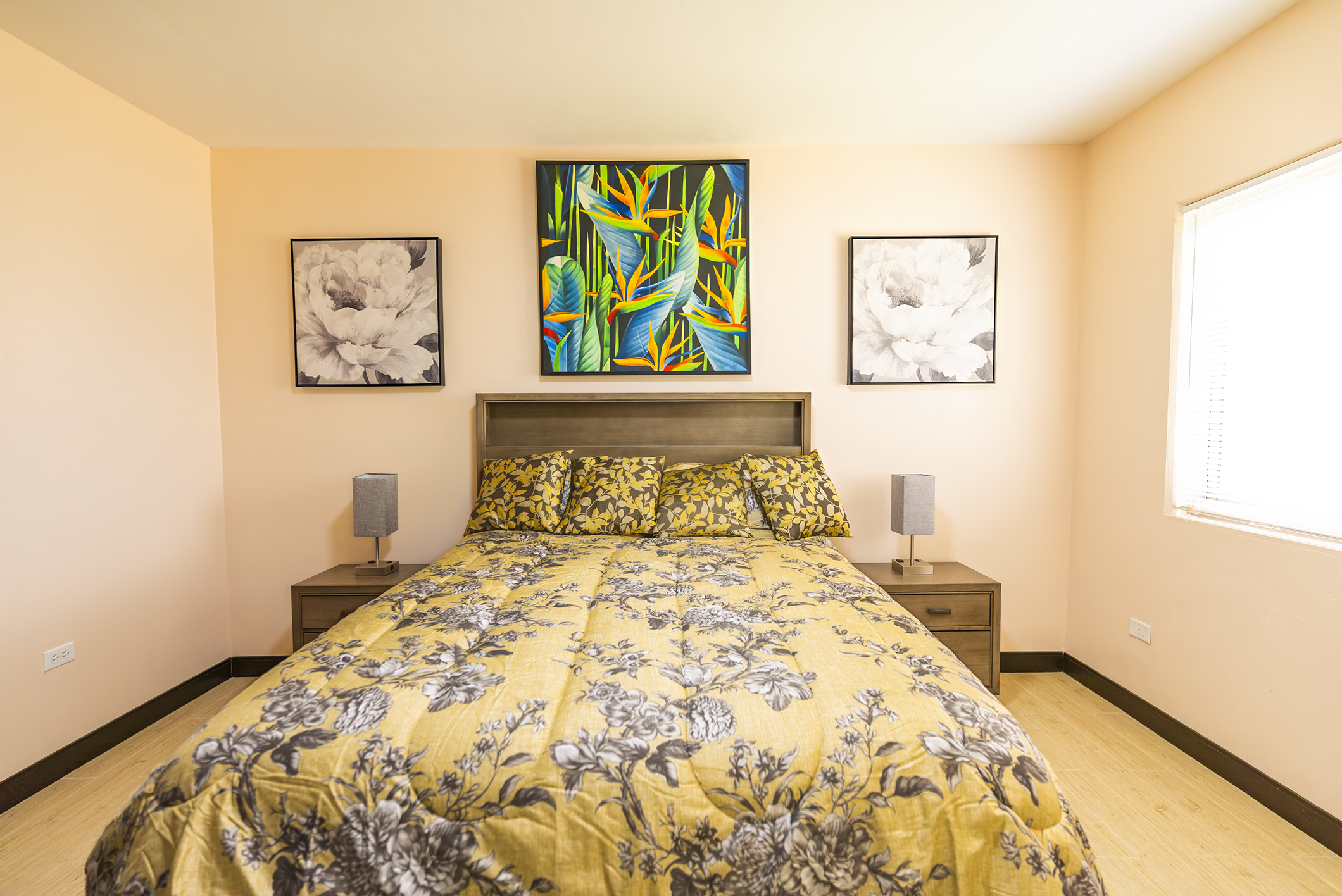 Front view of the bedroom with a bed that has yellow comforter